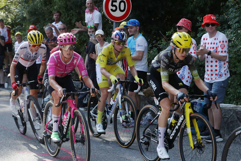 Competitors of the 2026 Tour de France Femmes race down a road.