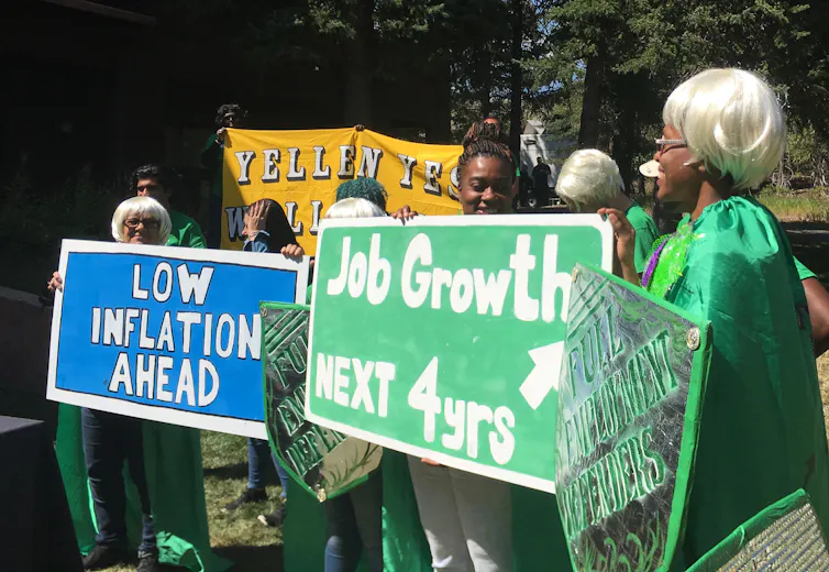 Activists with the left-leaning Fed Up coalition show support for then-Fed Chair Janet Yellen by wearing wigs in her hairstyle at the August 2017 Jackson Hole conference.
