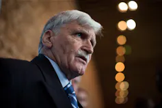 A man with grey hair and a moustache.