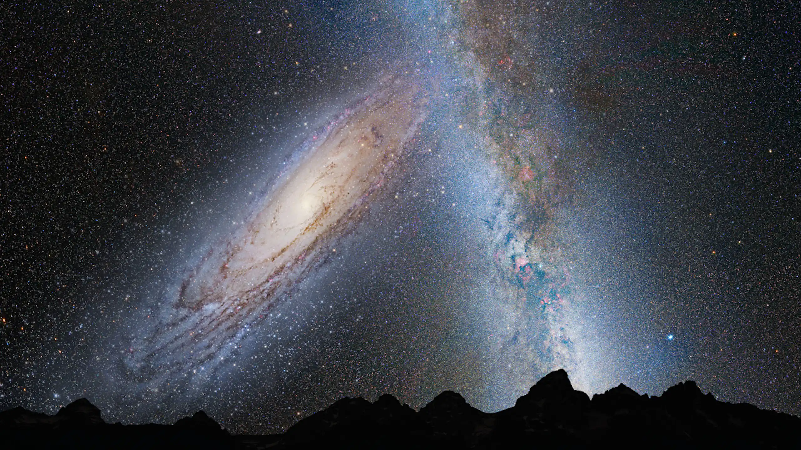 Two galaxies in the night sky, merging into one.