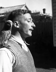 Black and white photograph of the poet in profile with a bird sitting on his shoulder.