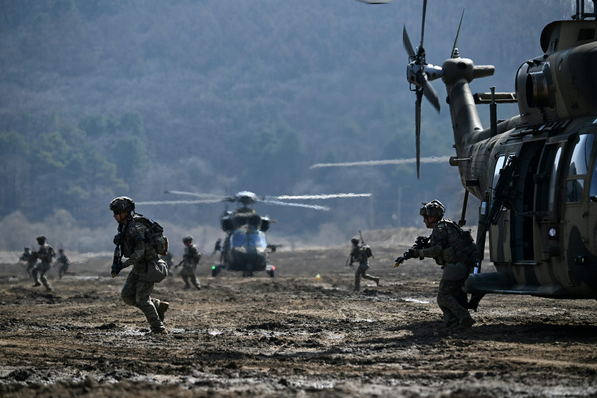 South Korean and US troops disembark from a military helicopter during a joint military exercise.