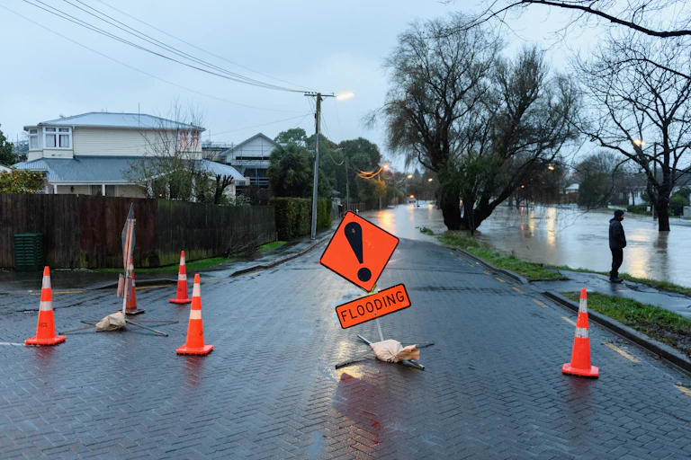 A flood warning sign as waters rise in a street