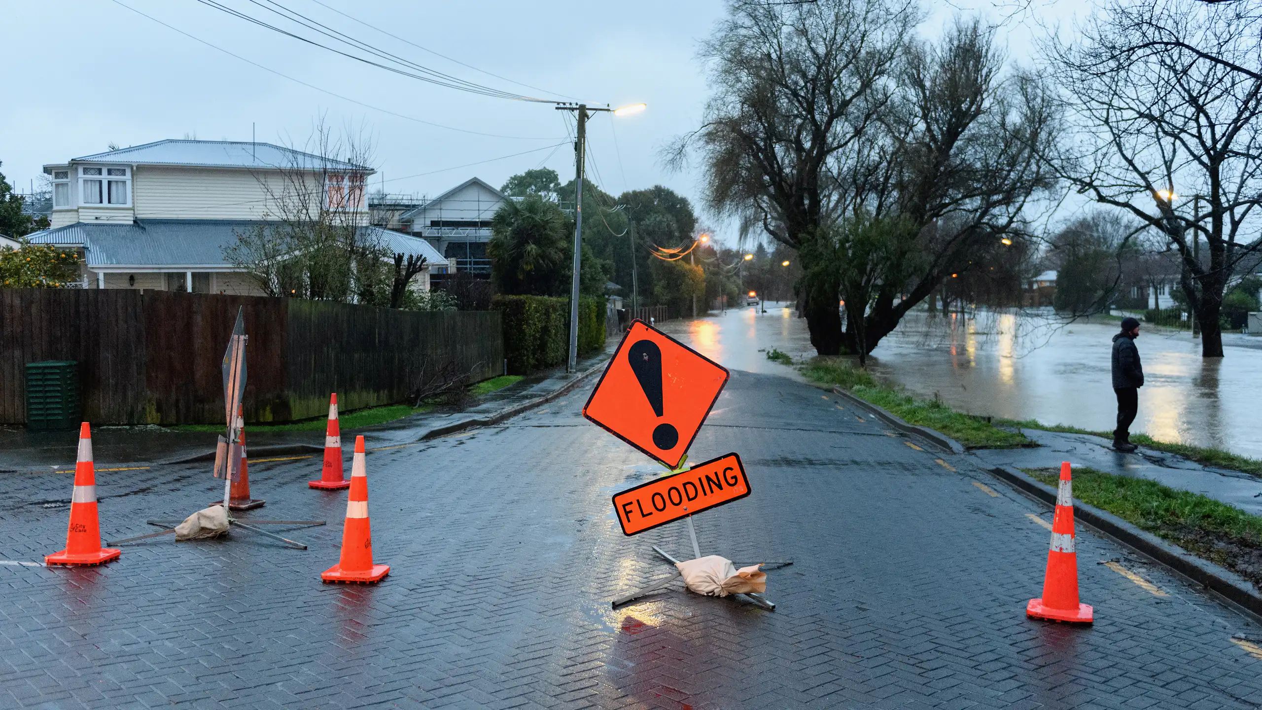 A flood warning sign as waters rise in a street