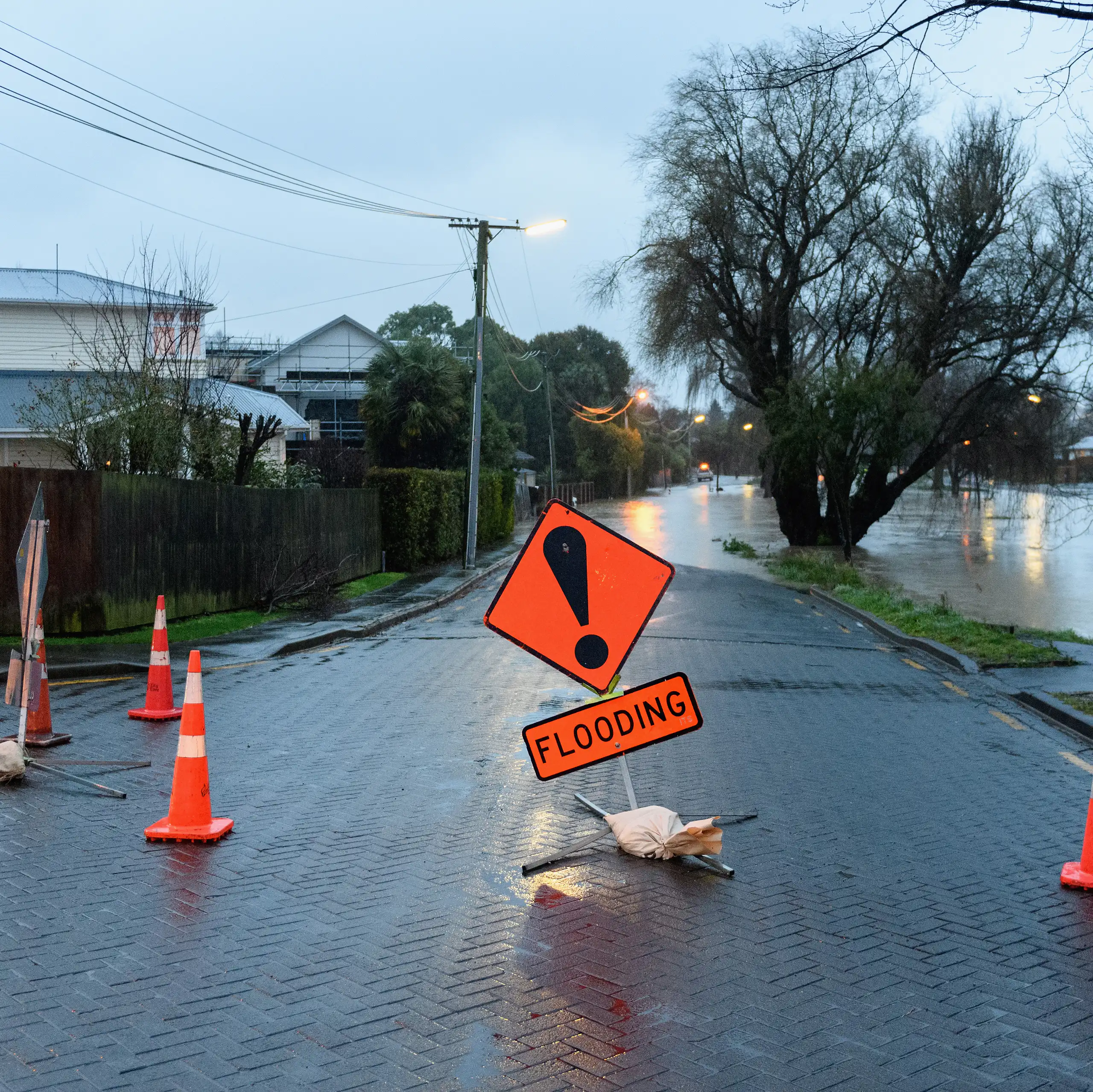 A flood warning sign as waters rise in a street
