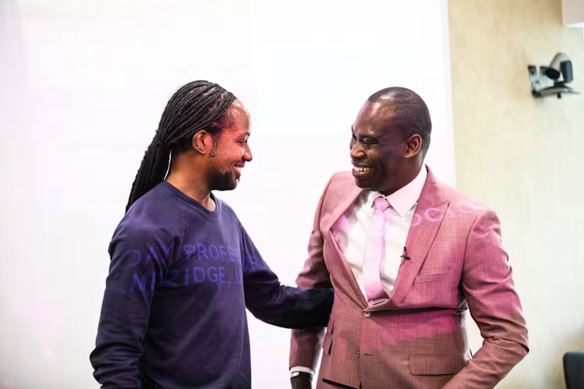 Two men smiling at each other