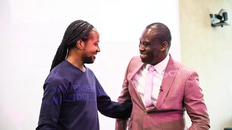 Two men smiling at each other