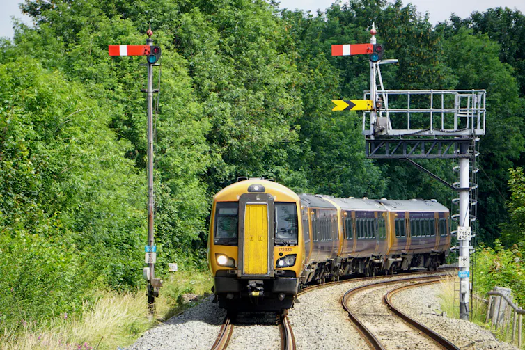Train going round the bend in english countryside