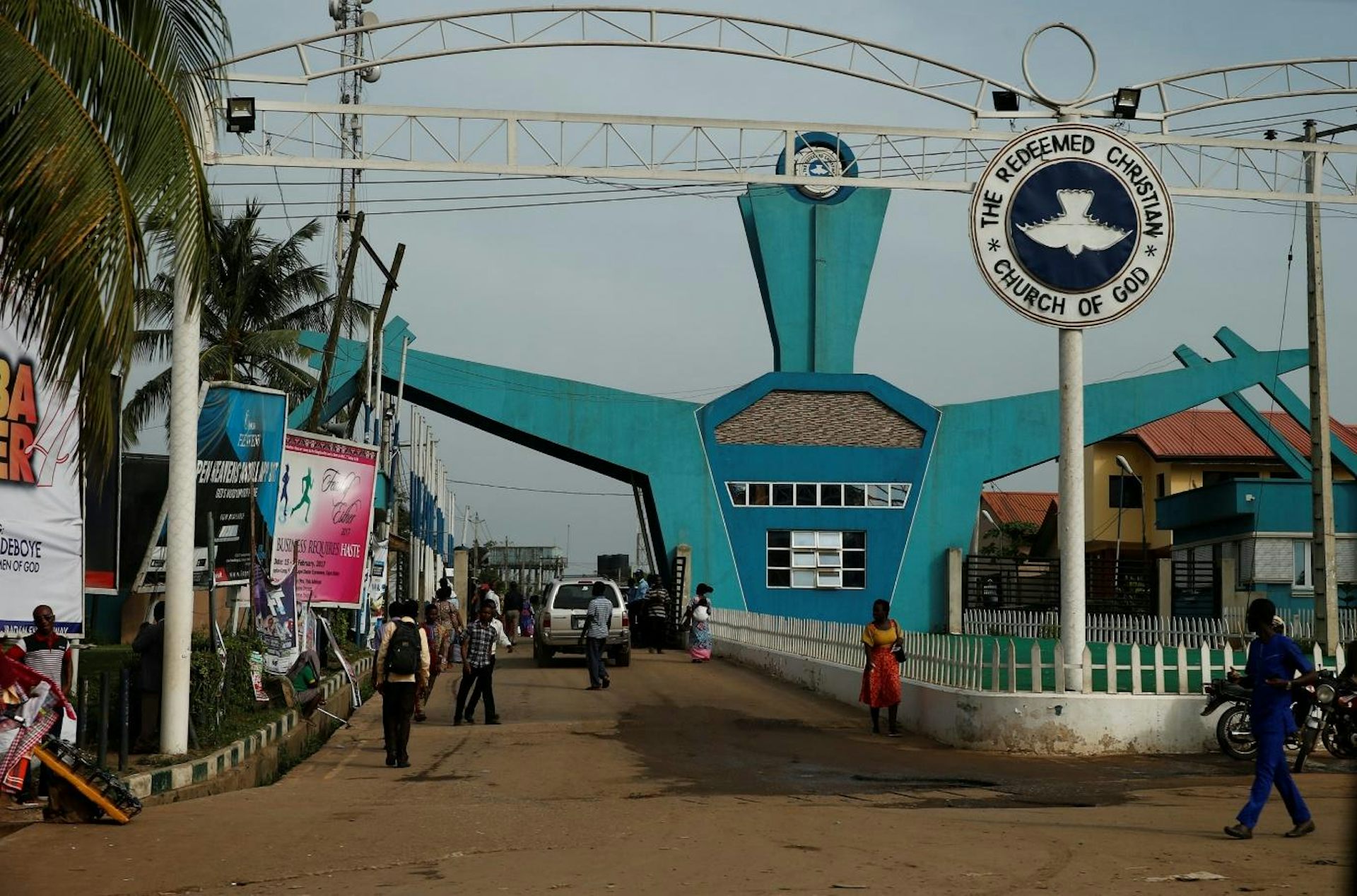 Avast blue entrance with a road in and a road out, people walking.