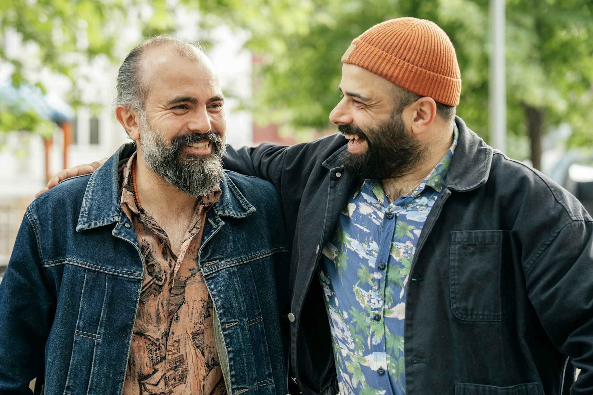 Two middle-aged men outside, laughing
