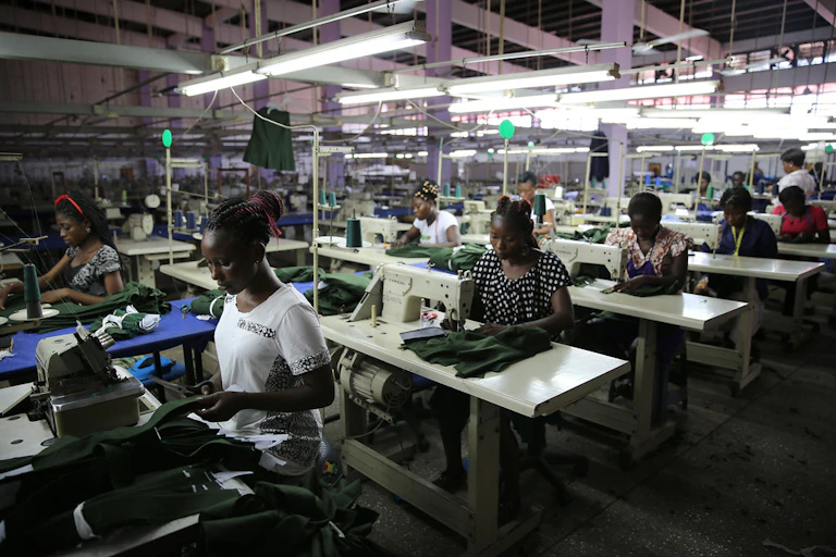 Workers sitting at sewing machines in a factory