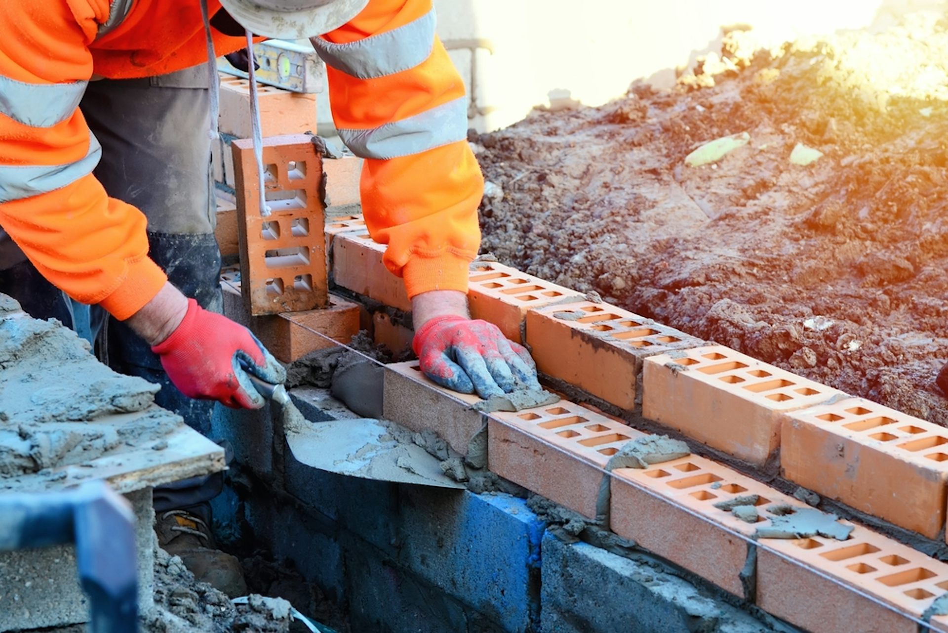 Person laying bricks.
