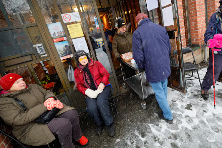 Swedes sitting outside in the snow.