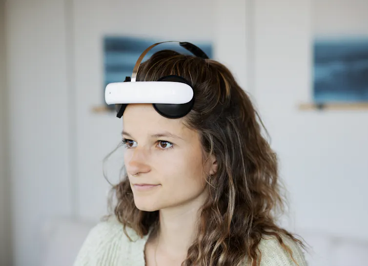 A woman wearing a Flow Neuroscience brain-stimulation headset