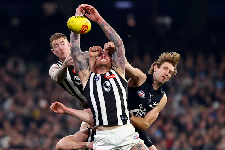 Nick Haynes of the Blues spoils a mark by Beau McCreery and Tim Membrey of the Magpies.