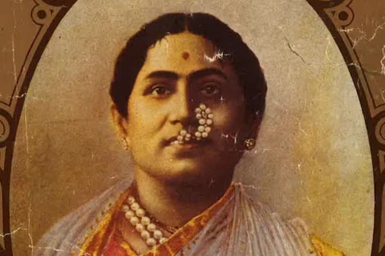 An old photo of an Indian man dressed in the stage costume of a woman.