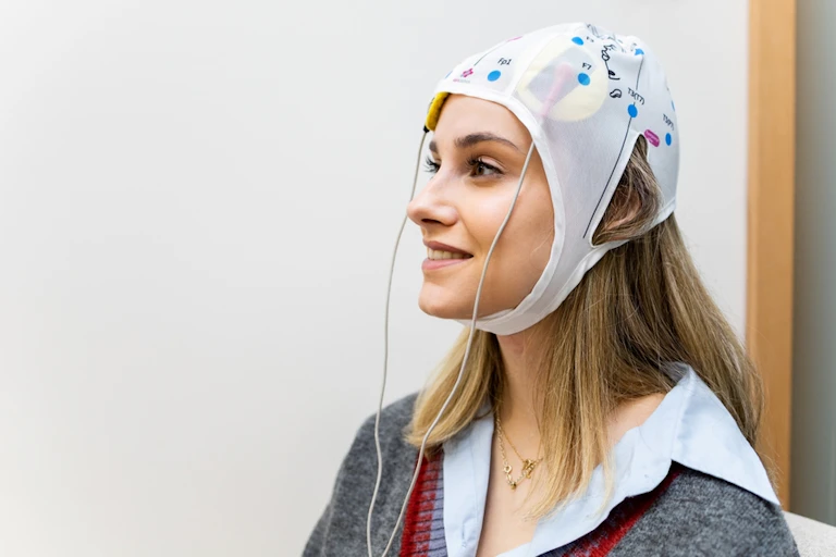 A young woman wearing a transcranial direct current stimulation cap