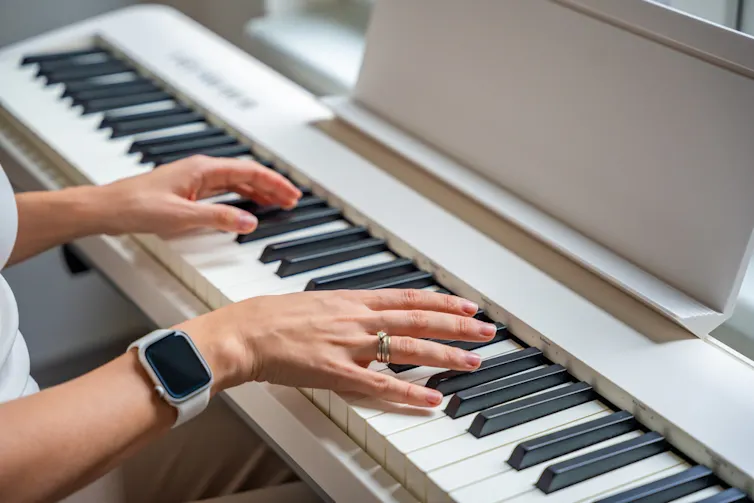 Close-up shot of a person playing piano