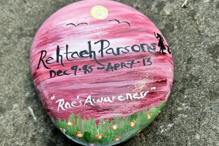 Stones with the words Rehtaeh Parsons painted on them are photographed in different locations.