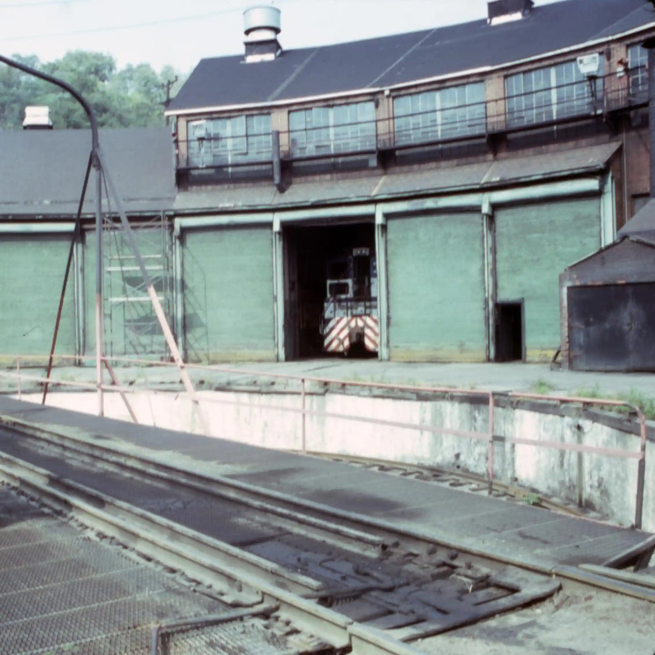An old industrial building along a railroad.