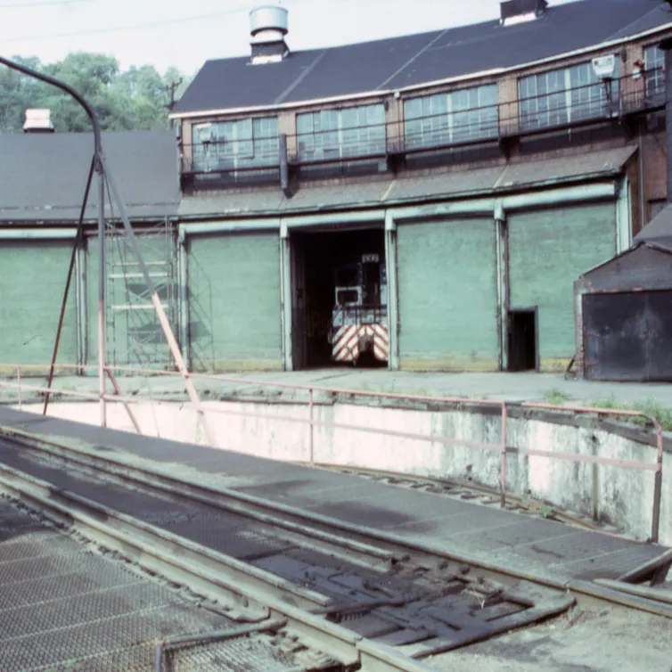 An old industrial building along a railroad.