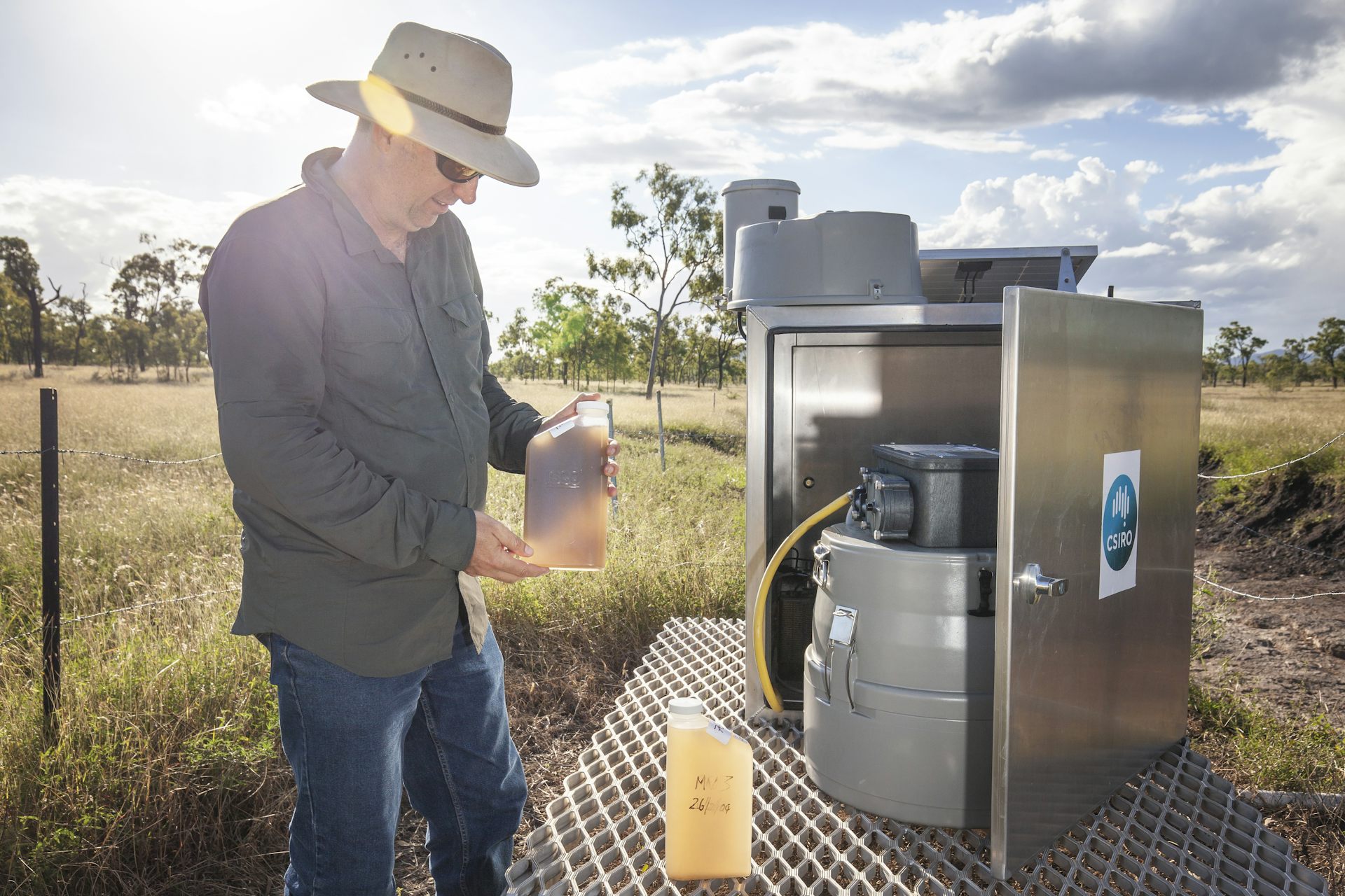 Scientist collecting sediment laden water samples