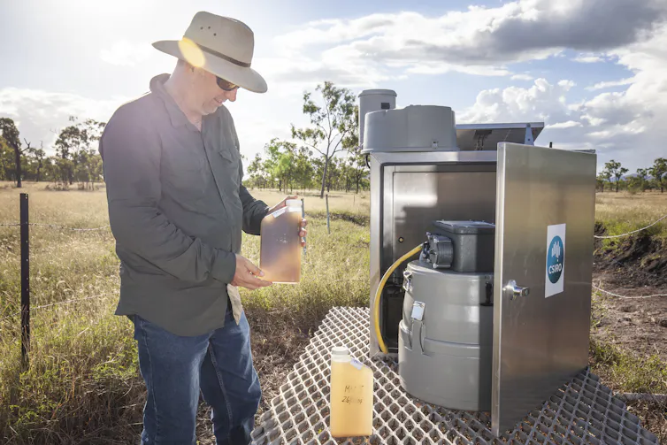 Scientist collecting sediment laden water samples