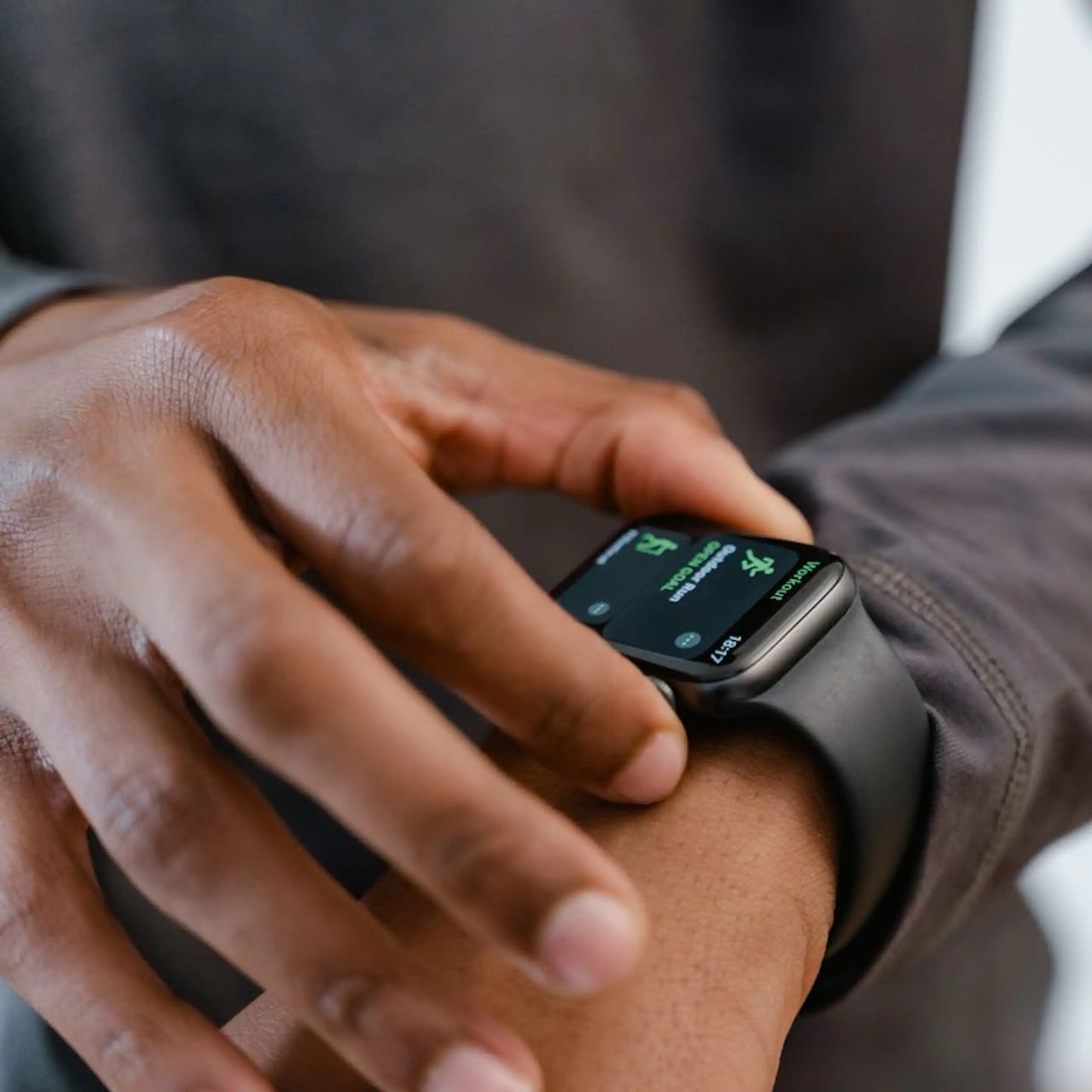 Man checking fitness tracker on wrist
