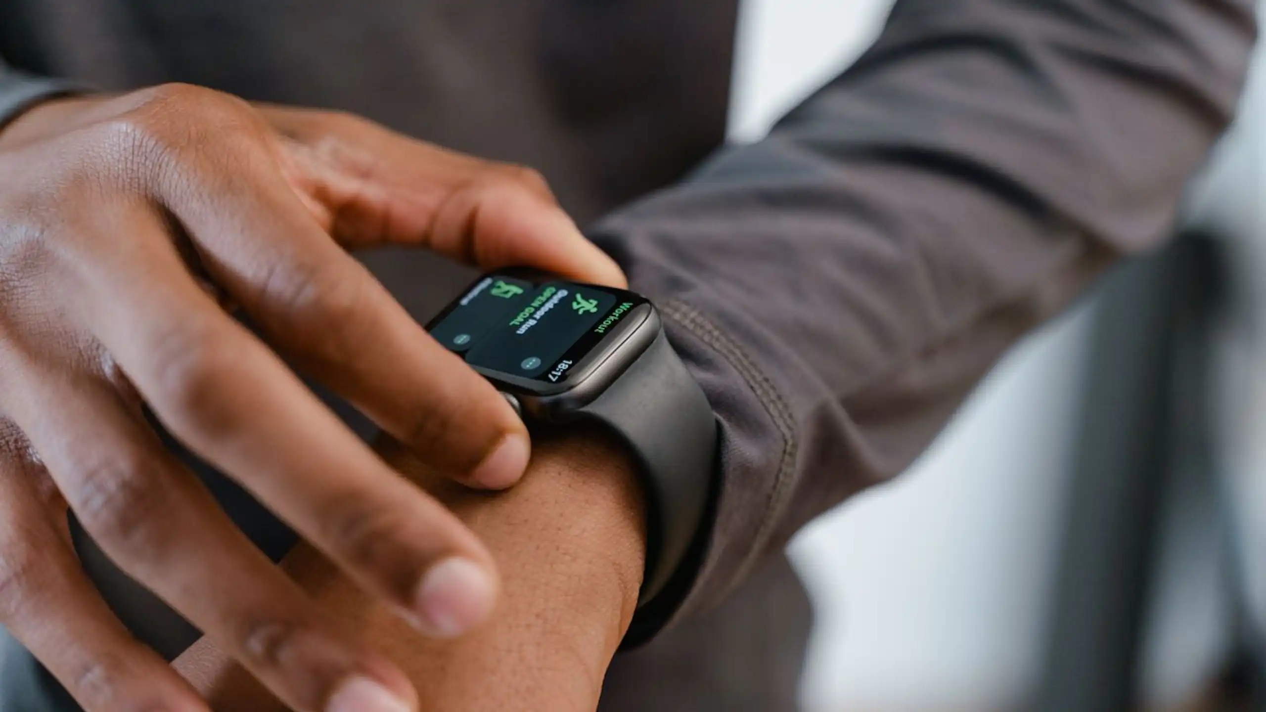 Man checking fitness tracker on wrist