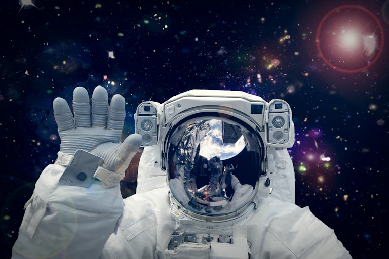 Close up crop of astronaut waving in space