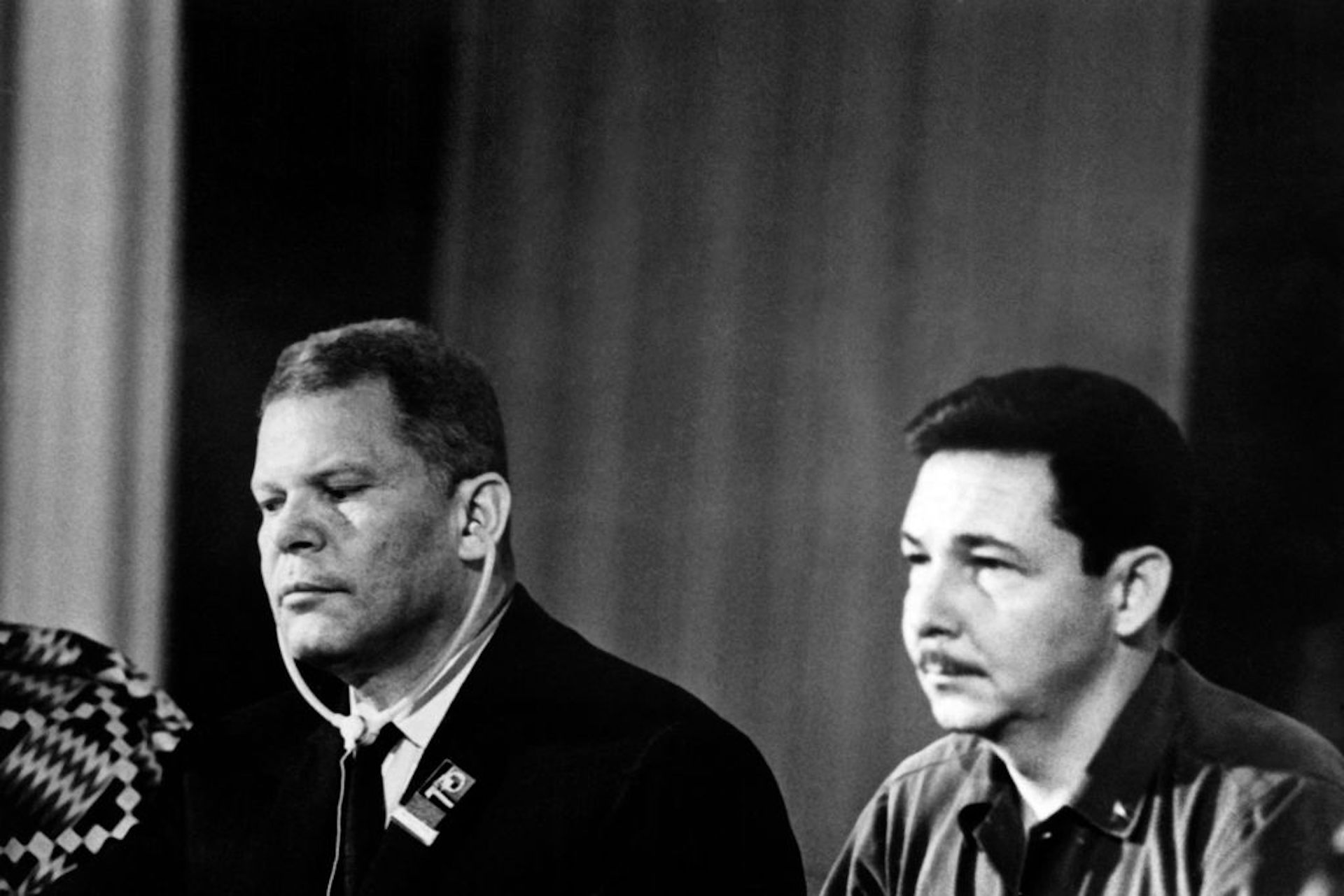 An old black-and-white photo of two men sitting.