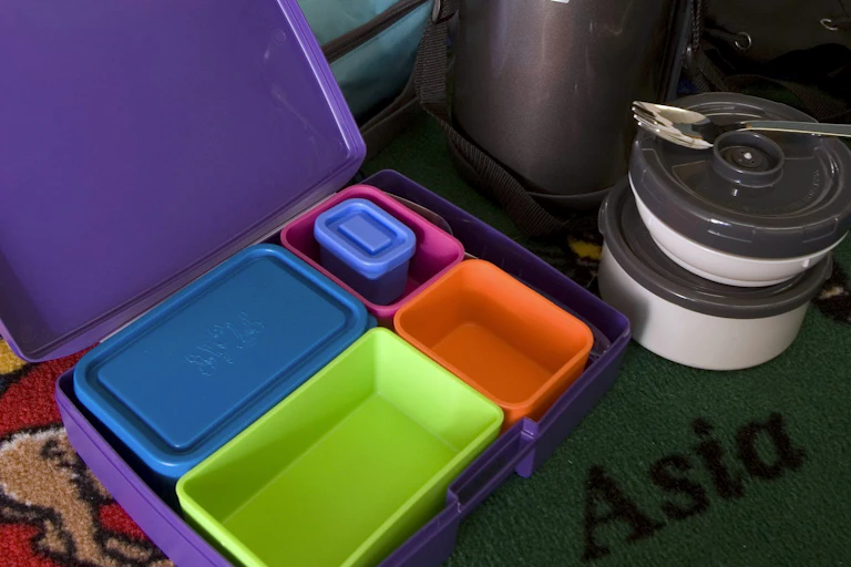 A thermos and empty tupperware containers.