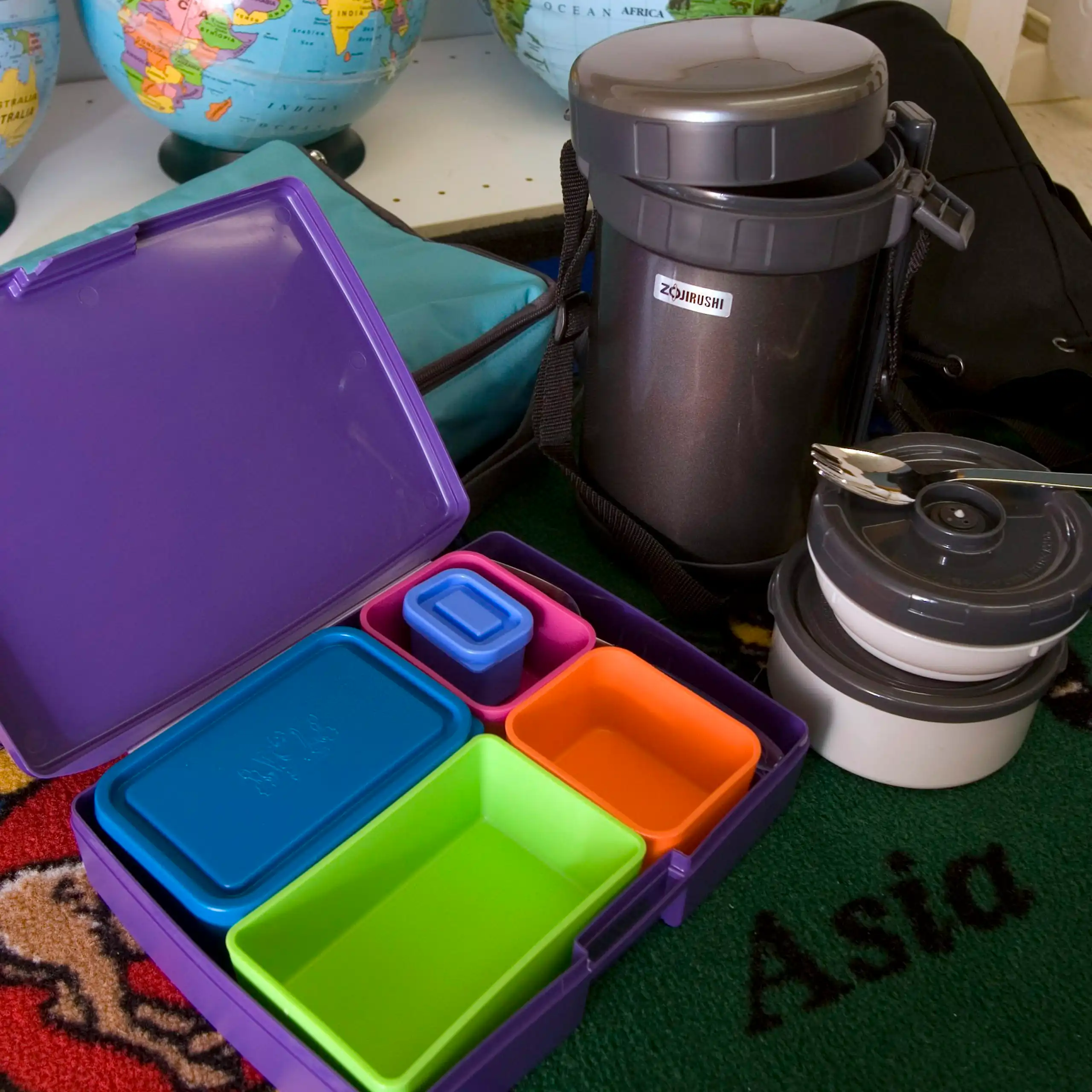 A thermos and empty tupperware containers.