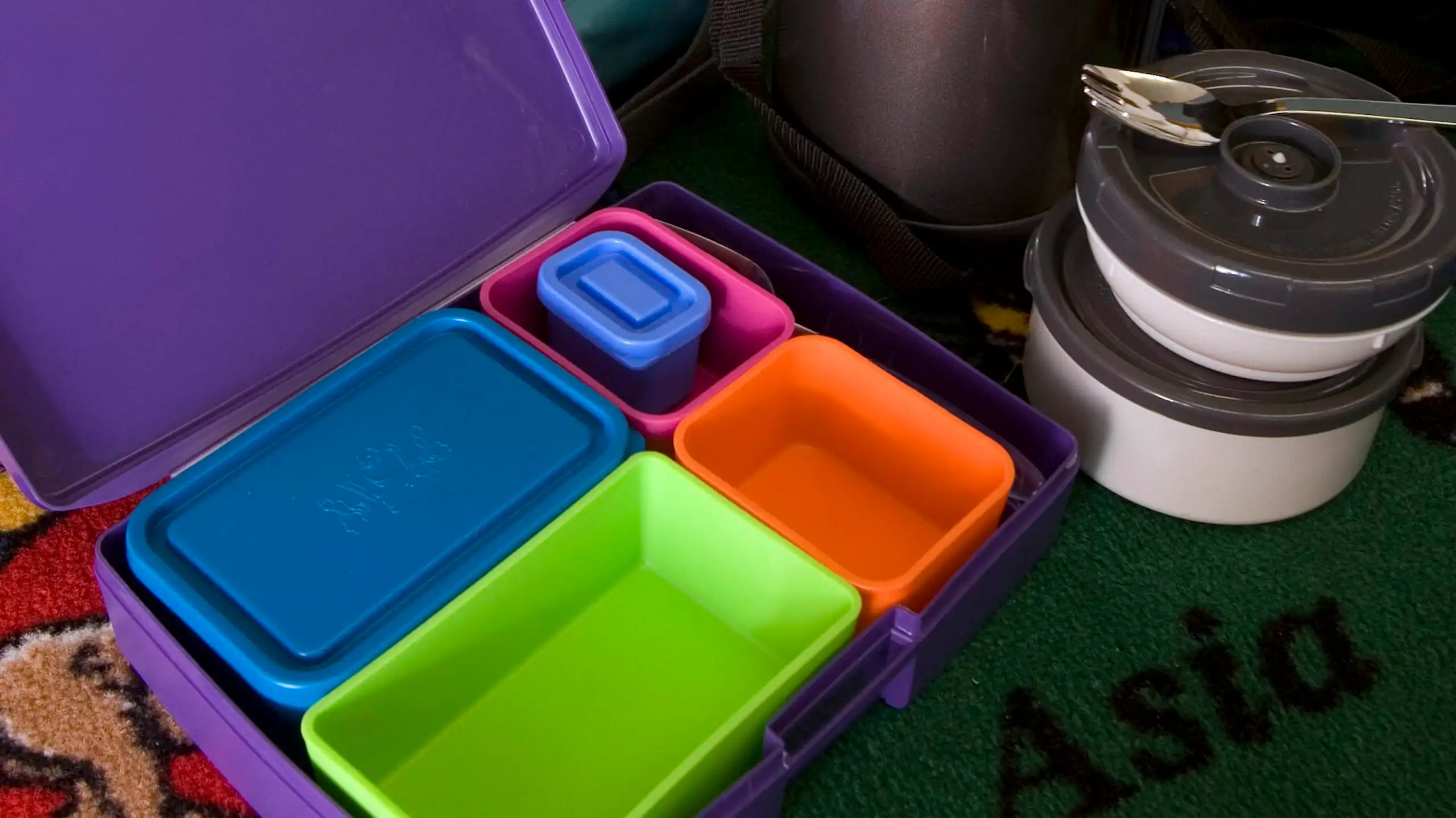 A thermos and empty tupperware containers.