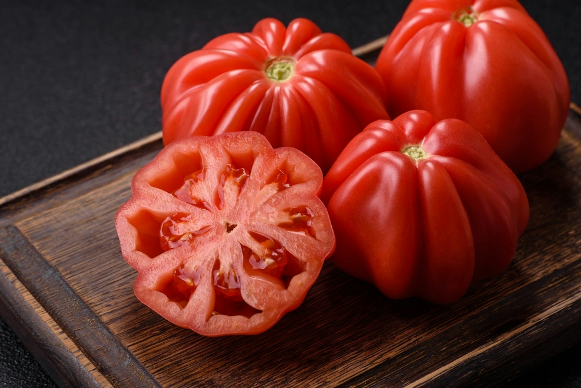 Tomatoes on a wooden board.