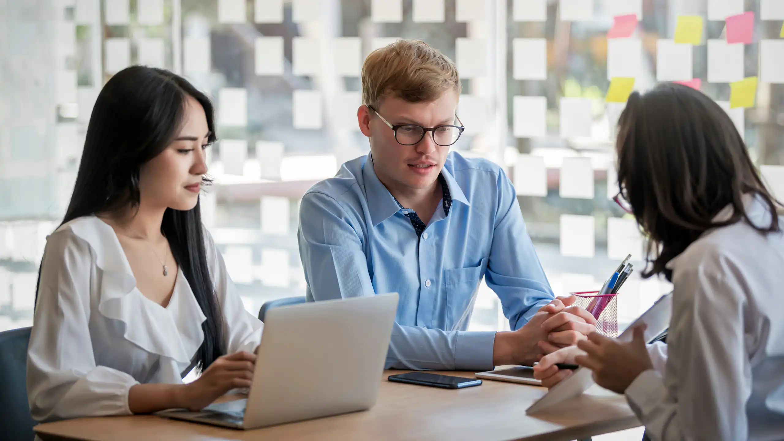A group of people having a conversation in a workplace setting