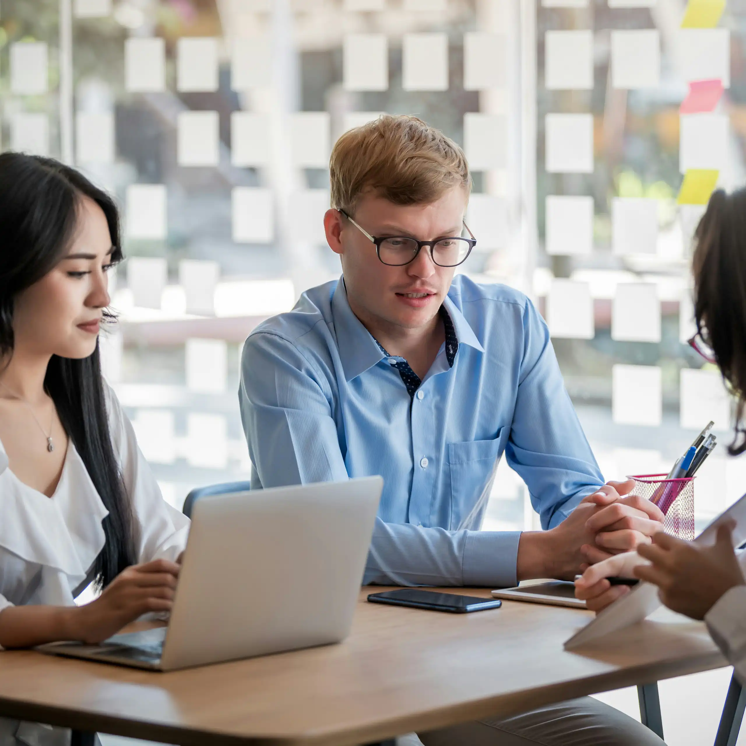 A group of people having a conversation in a workplace setting
