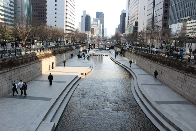 a river flows through a downtown area with tall buildings