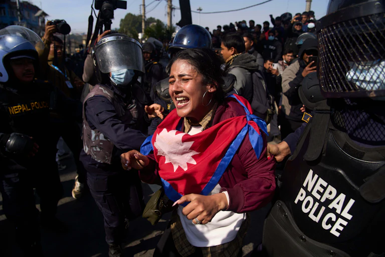 A young woman who was protesting is being detained by police.
