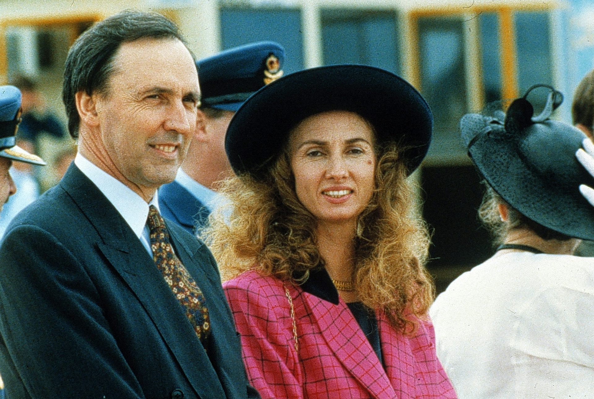 Paul Keating, in a suit and tie, with wife Annita, in a black hat and pink jacket.