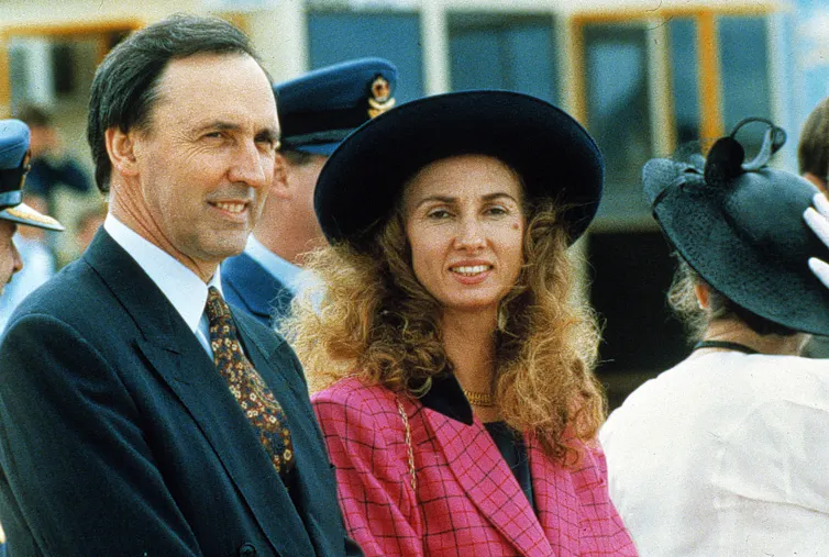 Paul Keating, in a suit and tie, with wife Annita, in a black hat and pink jacket.