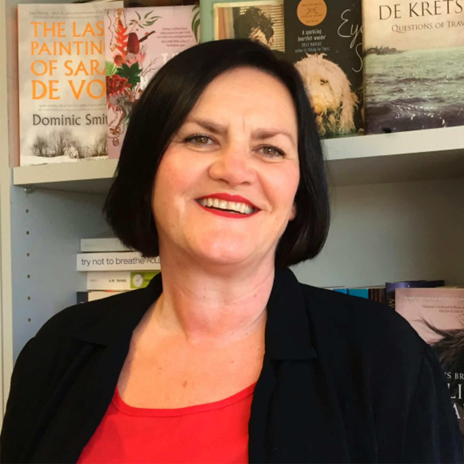 Jane Palfreyman, in a black jacket and red top.