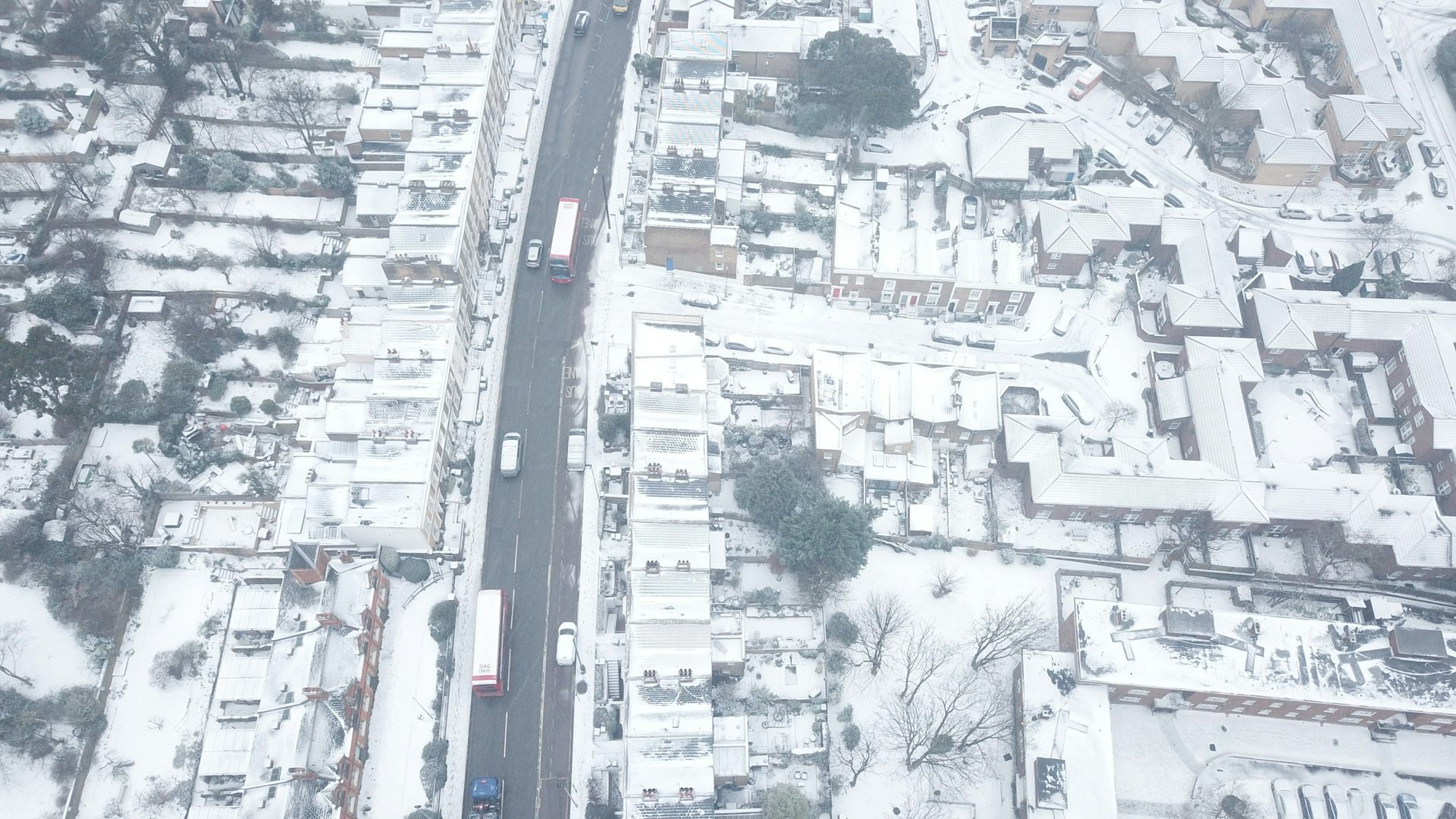 drone shot of london streets covered in snow