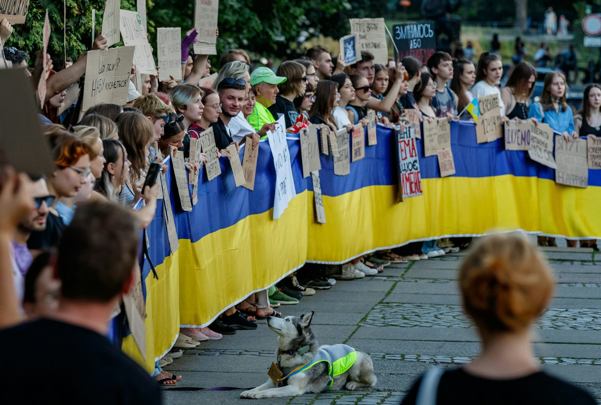 Ukrainians protesters with a large banner in the national colours.