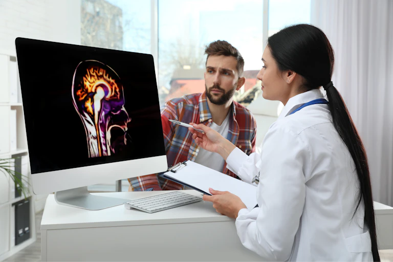 Neurologist showing brain scan to patient in clinic