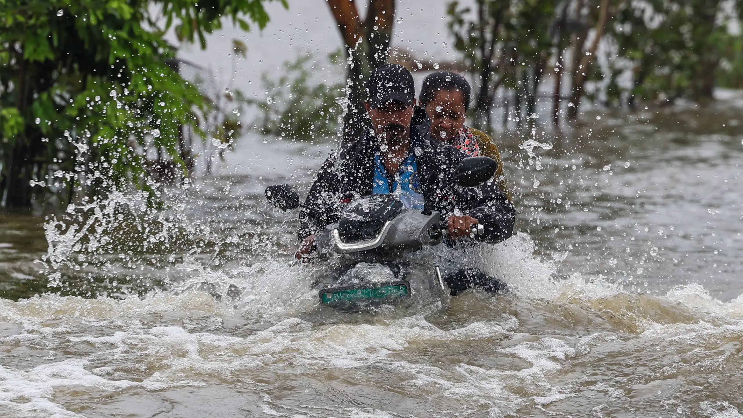 Men on motorbike in floods