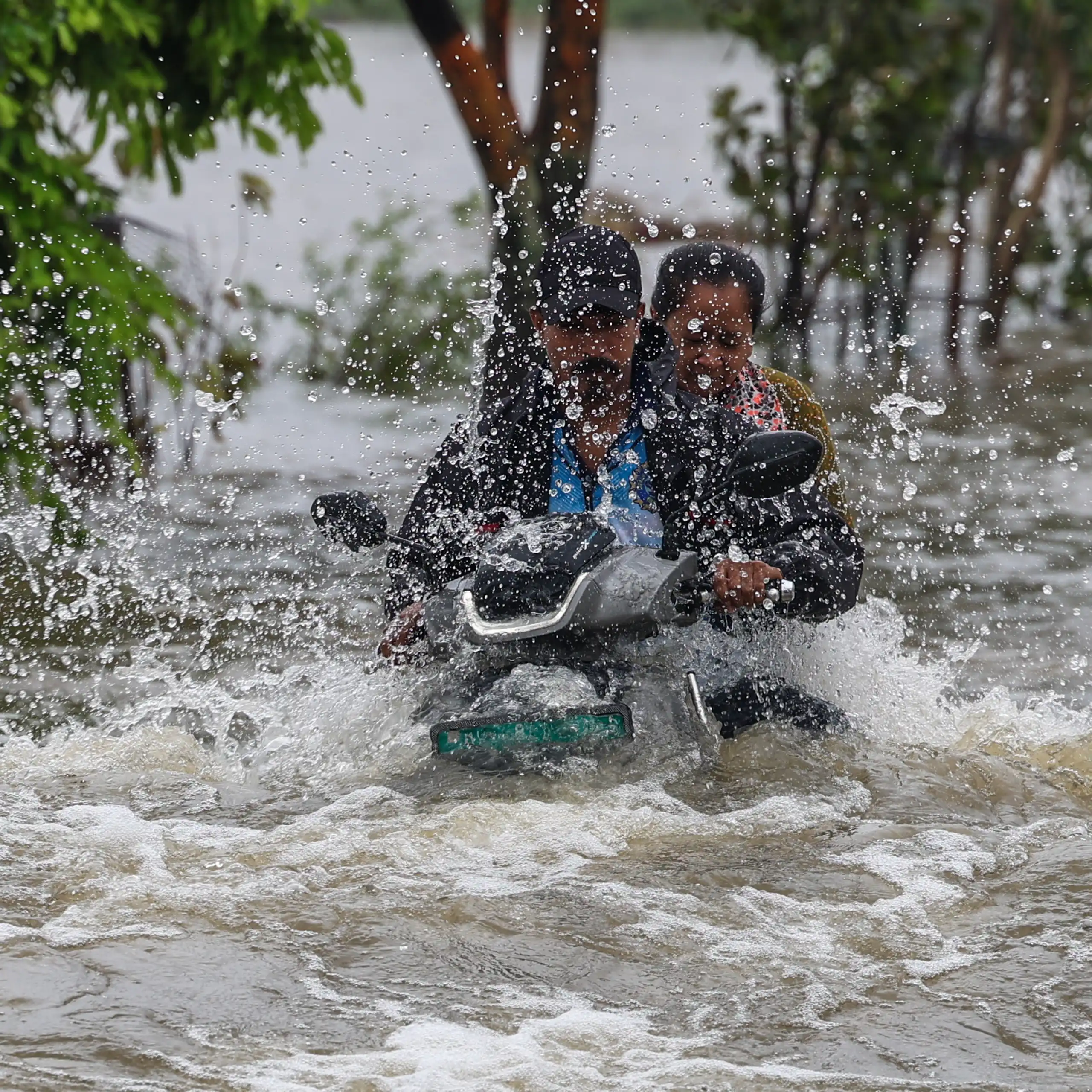 Men on motorbike in floods