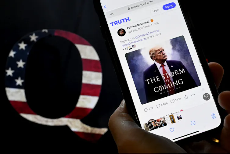 A letter Q is seen next to a social media account visible on a smartphone.