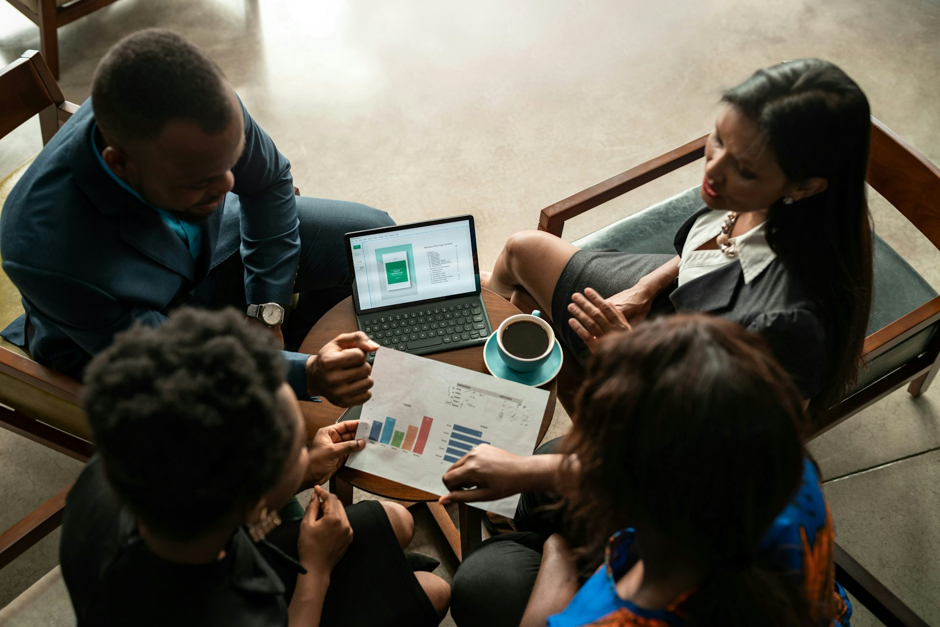 A group of professionals sitting around a table and chatting