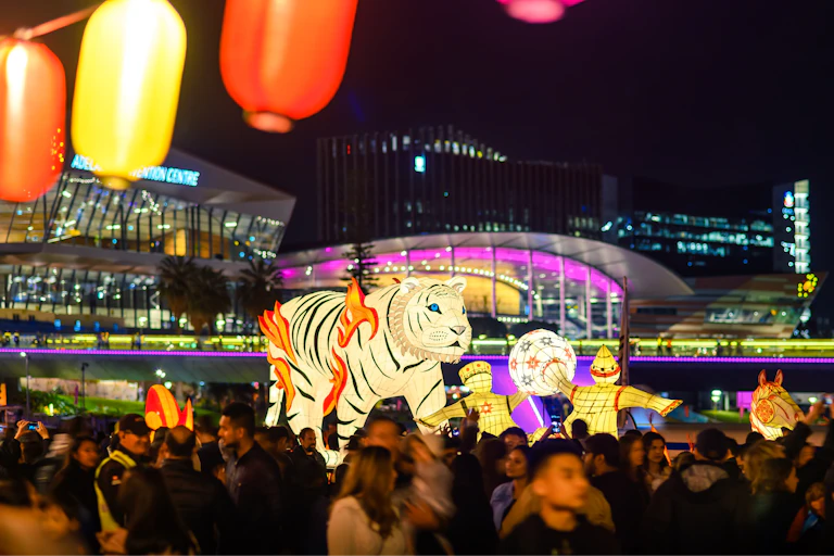 People carry a Hong Kong Dragon head carried through a crowd during the Moon Lantern event, as part of the 2019 OzAsia festival celebrations in Elder Park.